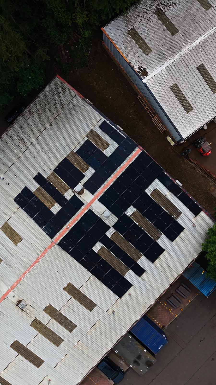 Aerial view of warehouse roof with solar panels