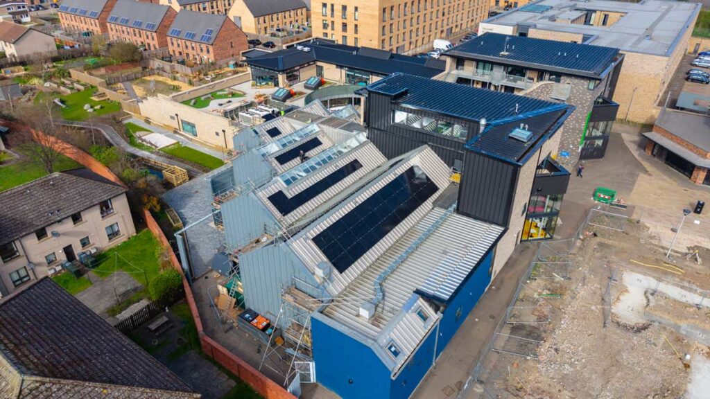 Aerial view of solar-panelled building under construction