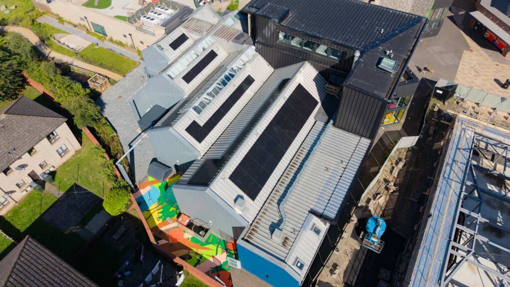 Aerial view of solar panels on a modern building roof