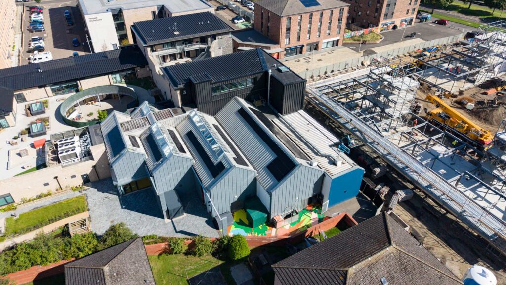 Aerial view of modern buildings beside construction site