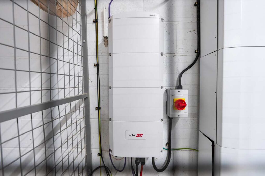 SolarEdge inverter and isolation switch mounted on wall