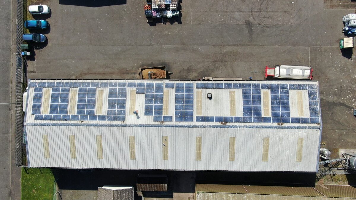 Aerial view of solar panels on industrial warehouse roof
