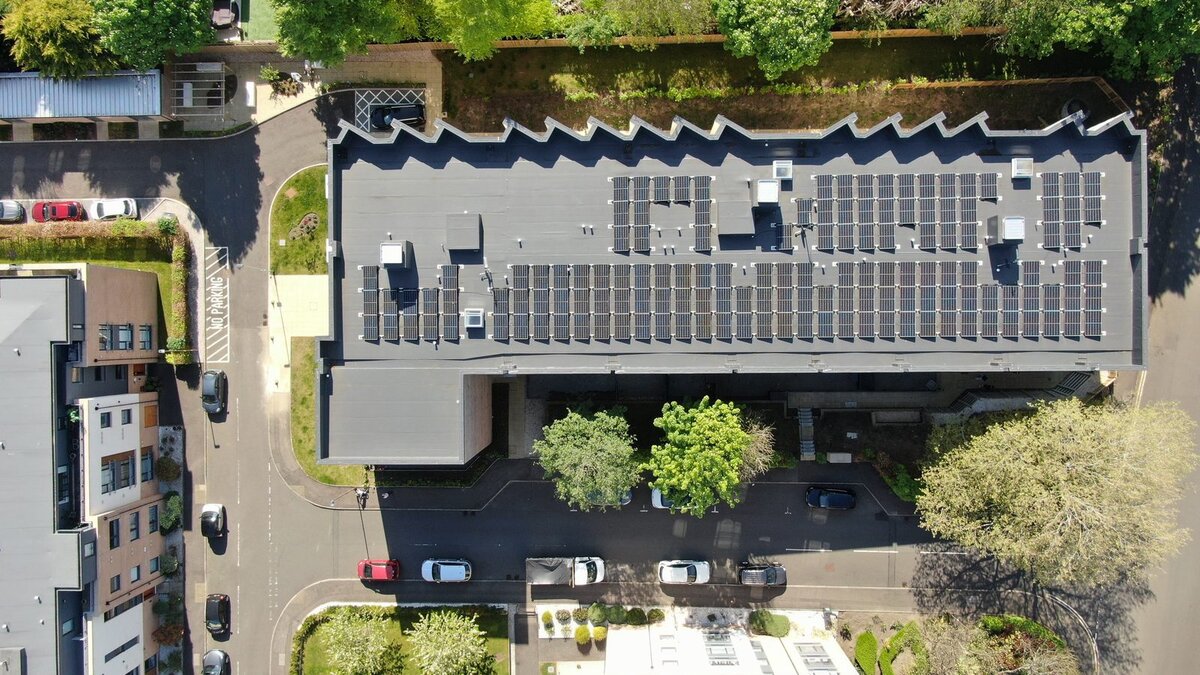 Aerial view of rooftop solar panels on urban building