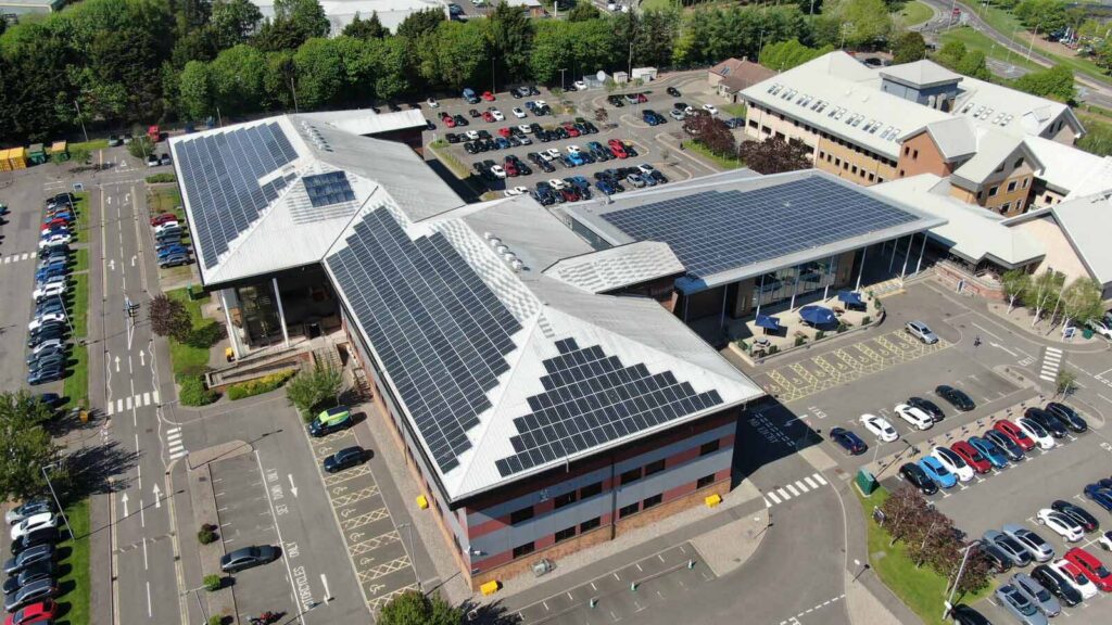 Aerial view of solar-panelled office buildings and car parks